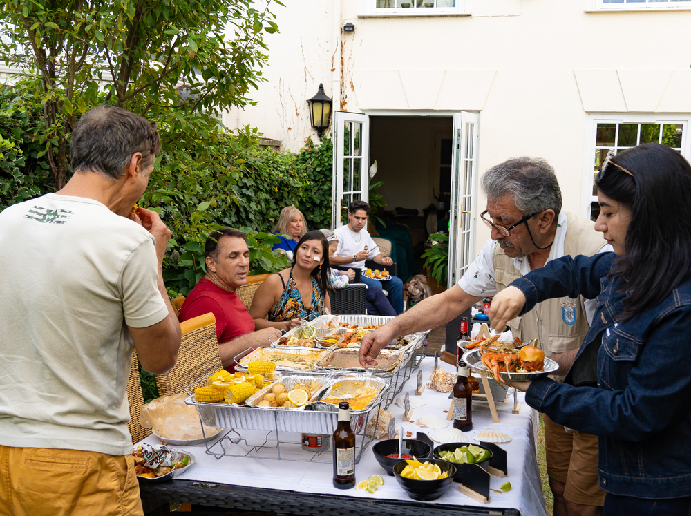 Family enjoying a seafood boil party privately catered by Hot n Juicy Shrimp LDN in London.